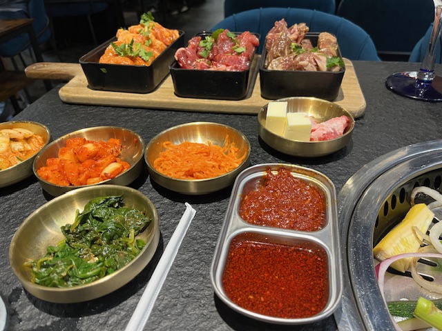 the set up of meats, vegetables and toppings ready to cook at Lava Korean Steakhouse in North Myrtle Beach, a new Korean Steakhouse South Carolina recently opened