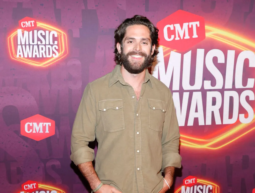 Thomas Rhett's music video - Thomas on the CMT red Carpet wearing a tan shirt. 