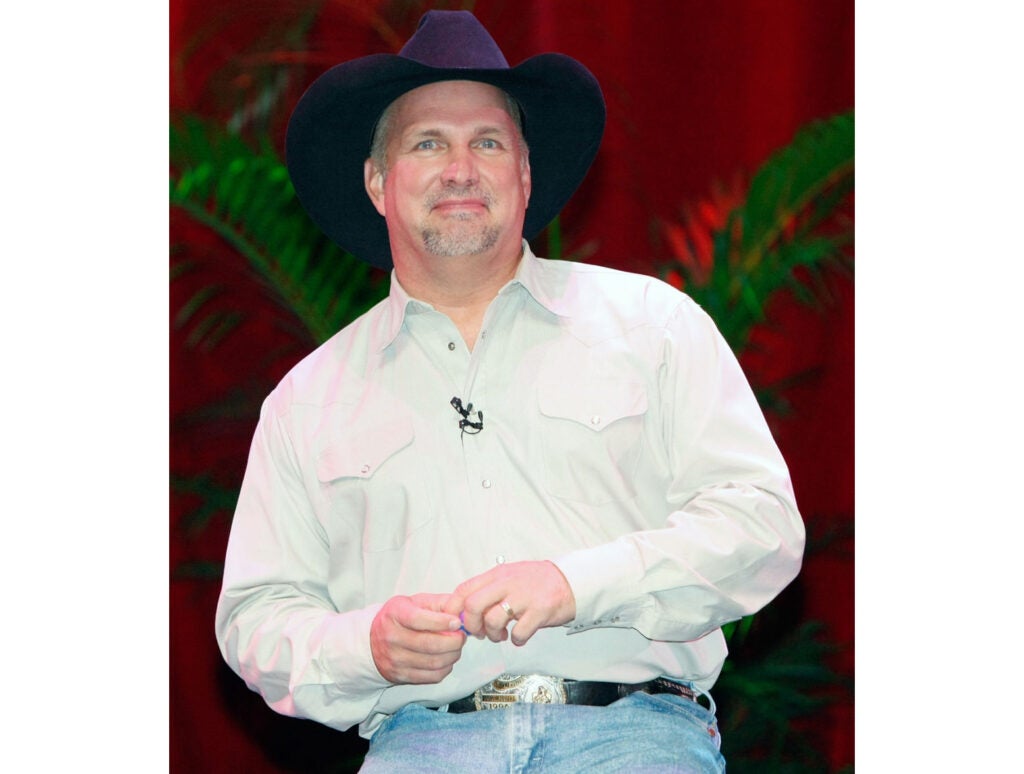 Garth Brooks Wants To Cover Michael Jackson - Garth wearing a white shirt and a black cowboy hat. 